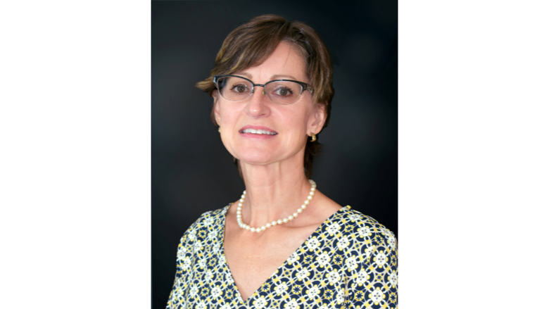 A woman wearing glasses and a necklace